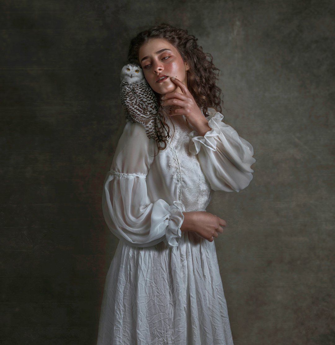 Studio portrait of a white woman with curly hair smiling