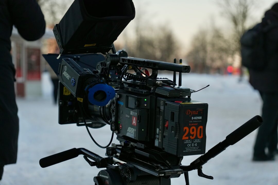 Professional video camera mounted on a tripod on a film set