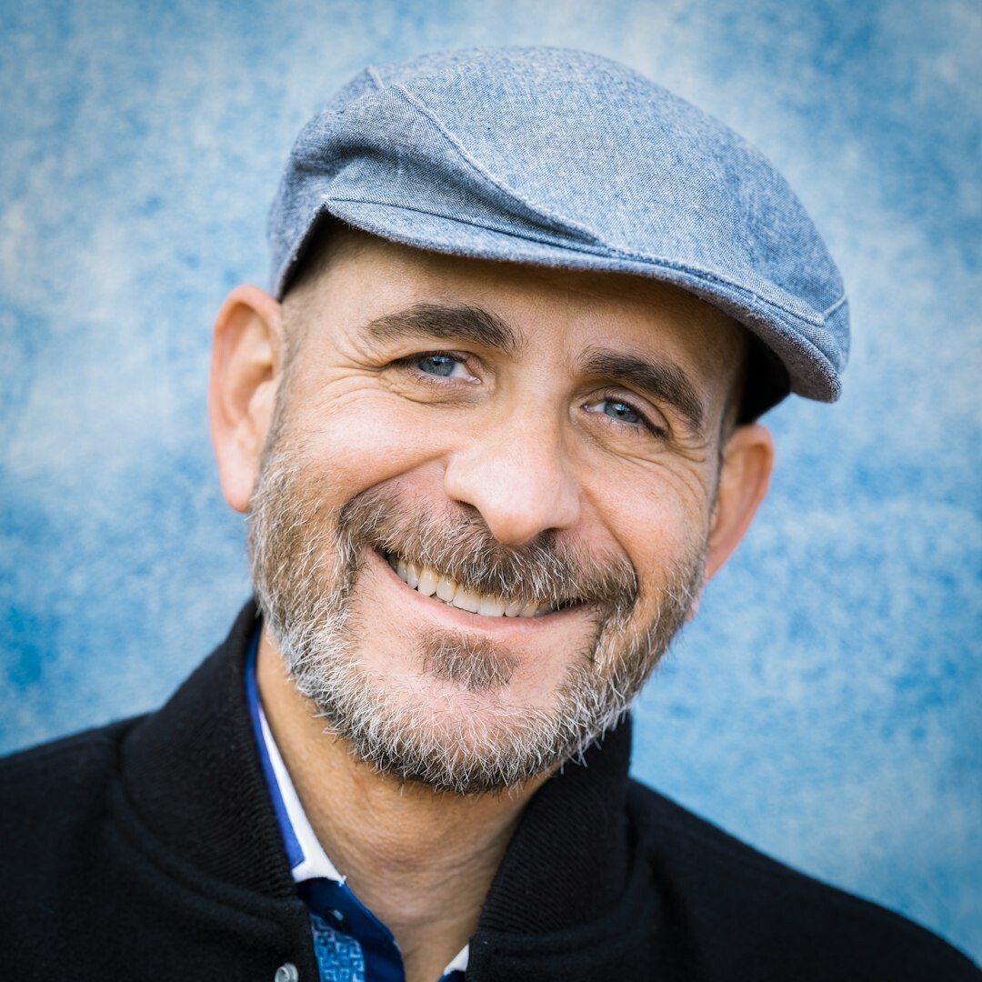 Studio portrait of a middle aged white man with short hair smiling